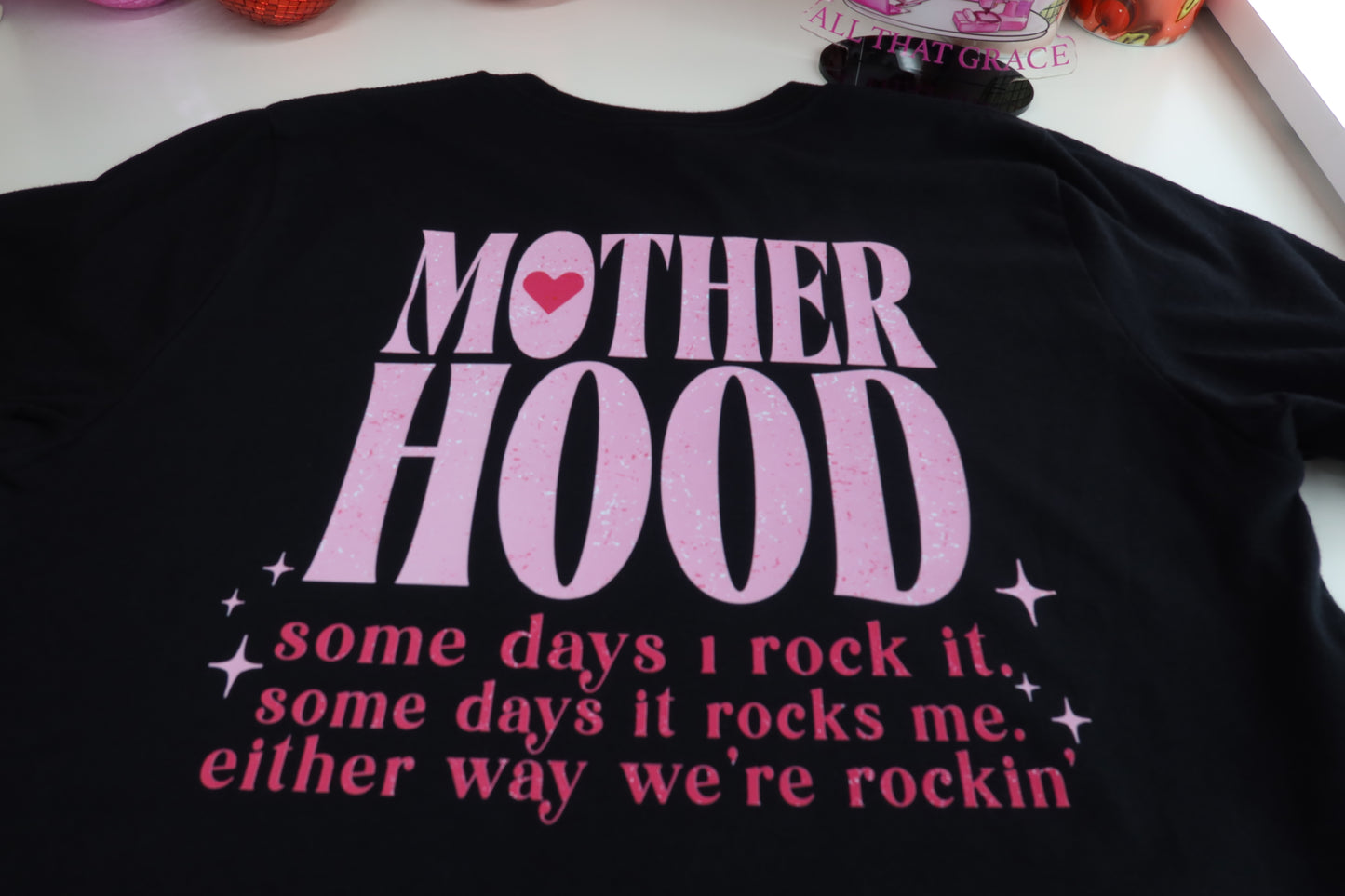 Motherhood Some Days I Rock It Some Days It Rocks Me Either Way We're Rocking in Black Tee