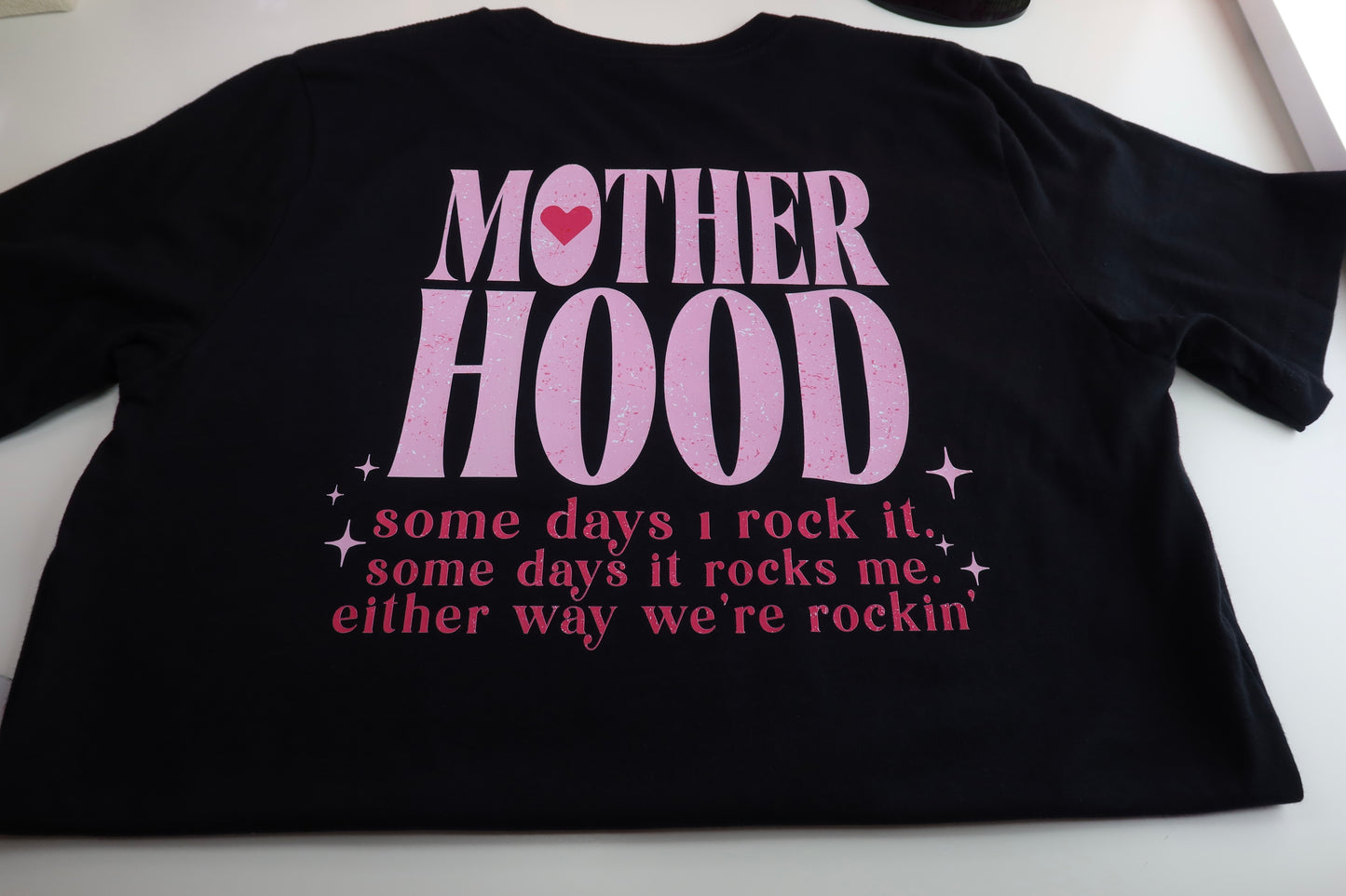 Motherhood Some Days I Rock It Some Days It Rocks Me Either Way We're Rocking in Black Tee